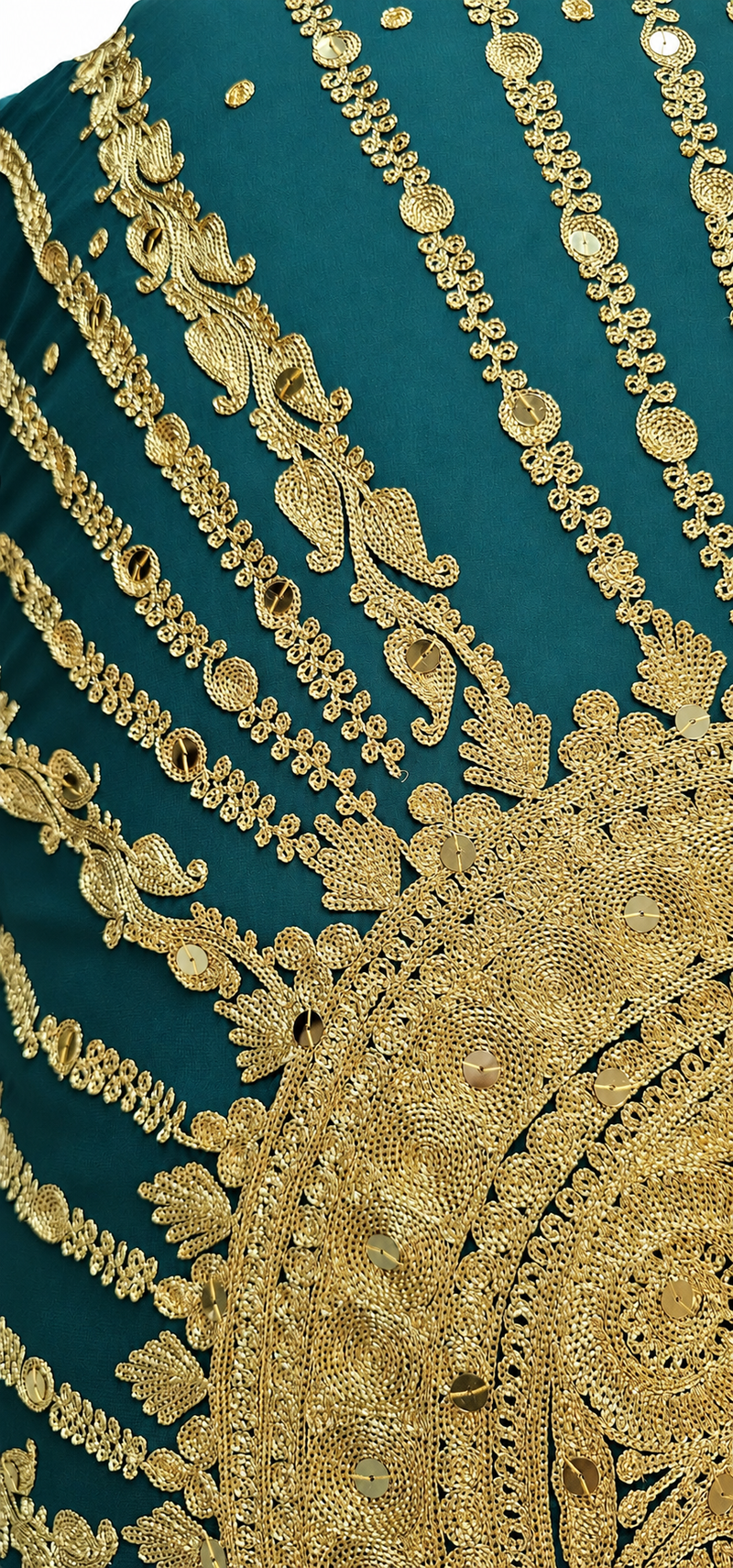 Gold embroidery detail on emerald silk