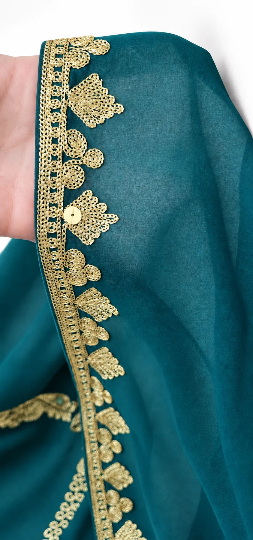 Close-up of bridal veil fabric and gold-trimmed edge