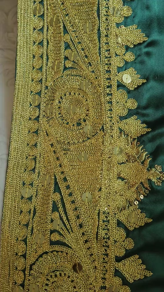 Emerald silk and gold embroidery in motion